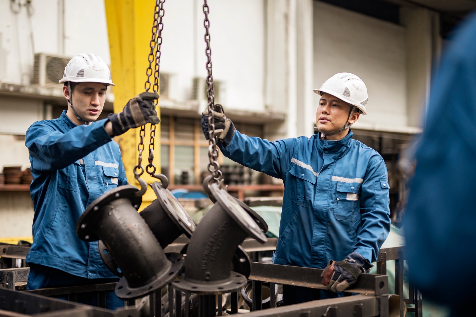 Blue collar workers working in steel factory